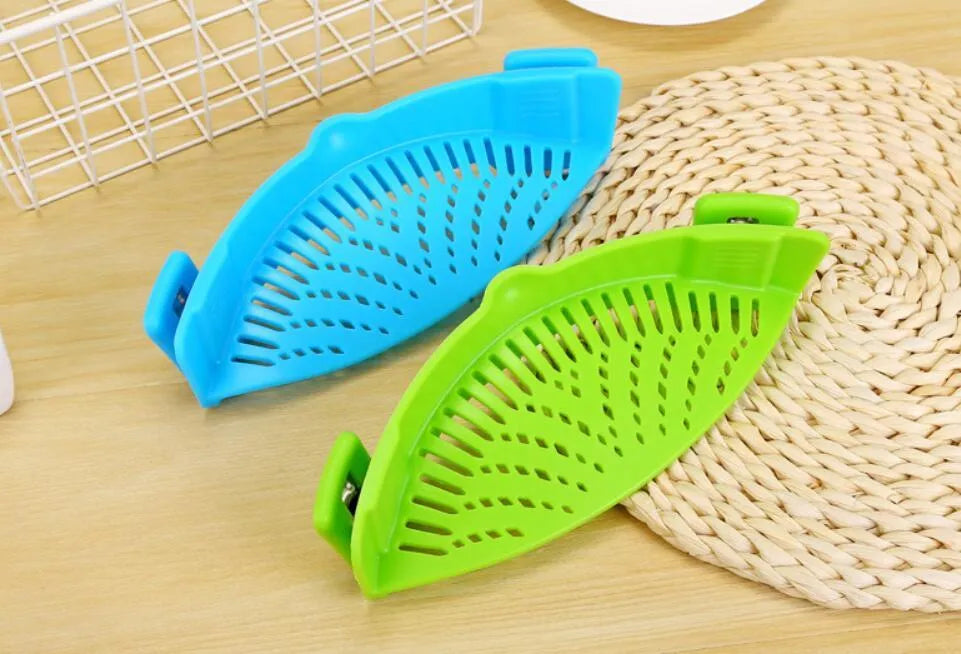 Silicone clip-on funnel strainer attached to a pot rim for draining liquids.