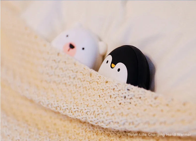Cartoon penguin polar bear USB rechargeable hand warmer and power bank unit.