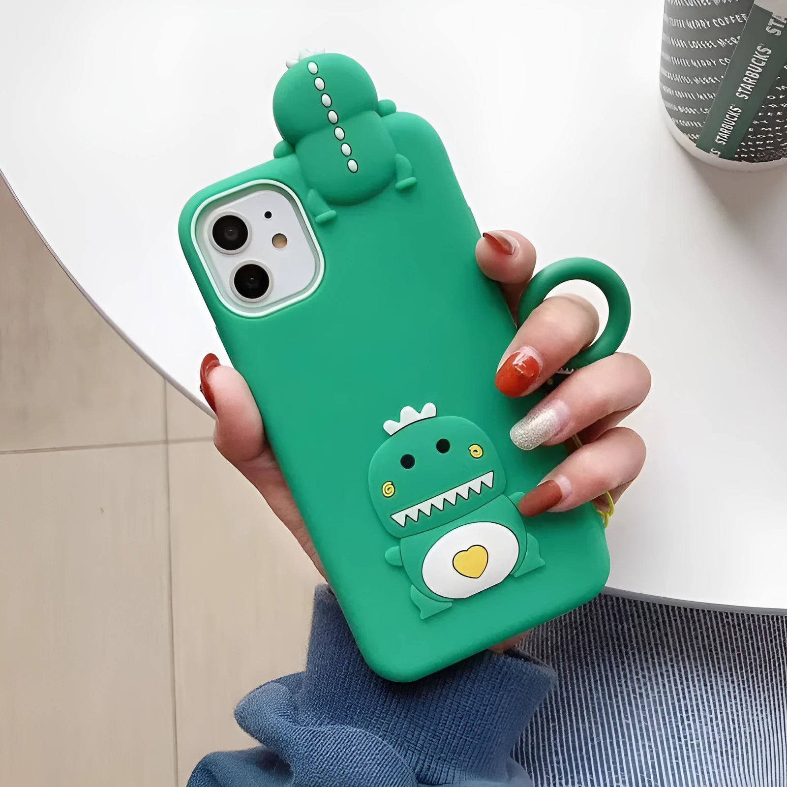 Green and yellow silicone iPhone cases with animal cartoon designs on a white background.