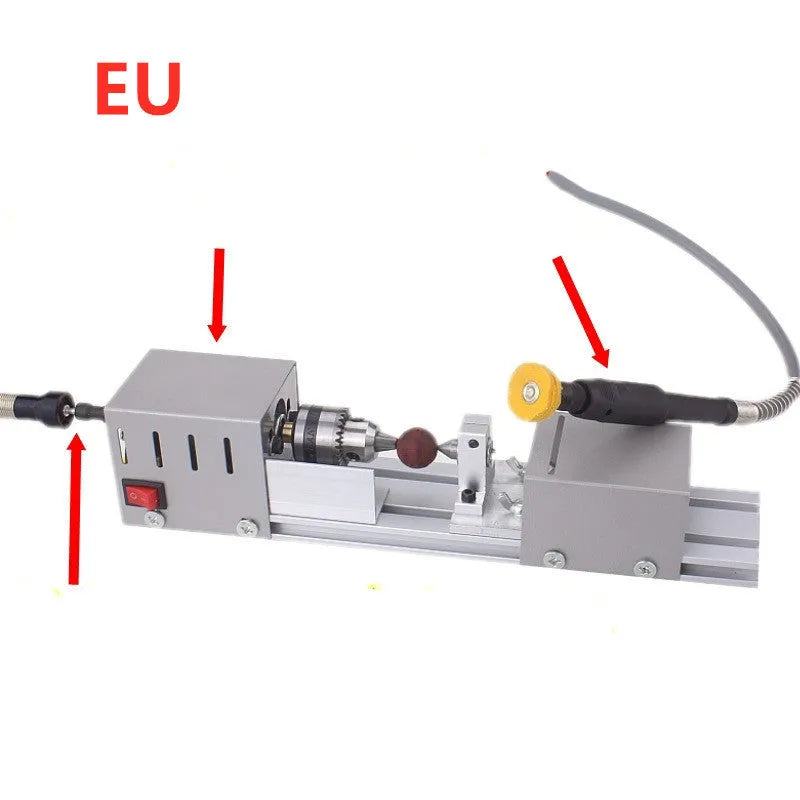Mini metal woodworking lathe with carving knives and accessories on workbench