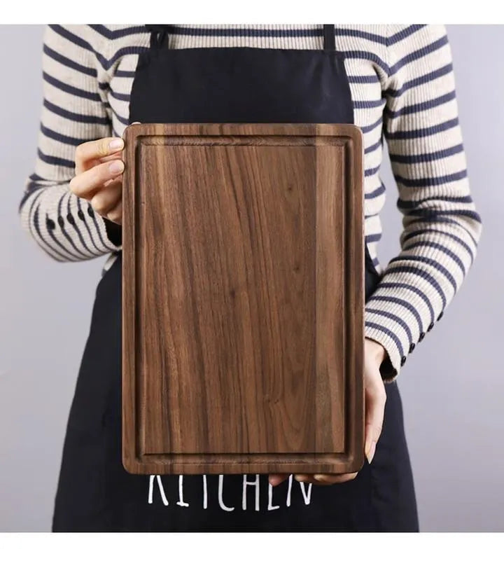Black walnut wood cutting board set showing rectangular and round boards with juice grooves and side handles