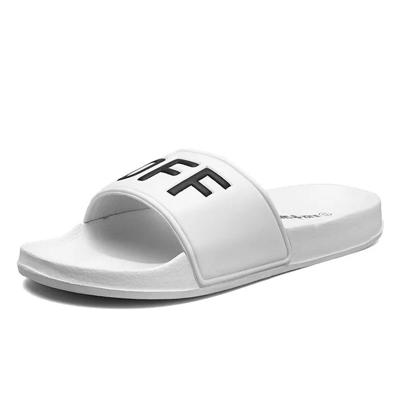 Large men's black and white open toe slippers with rubber soles on a plain background.