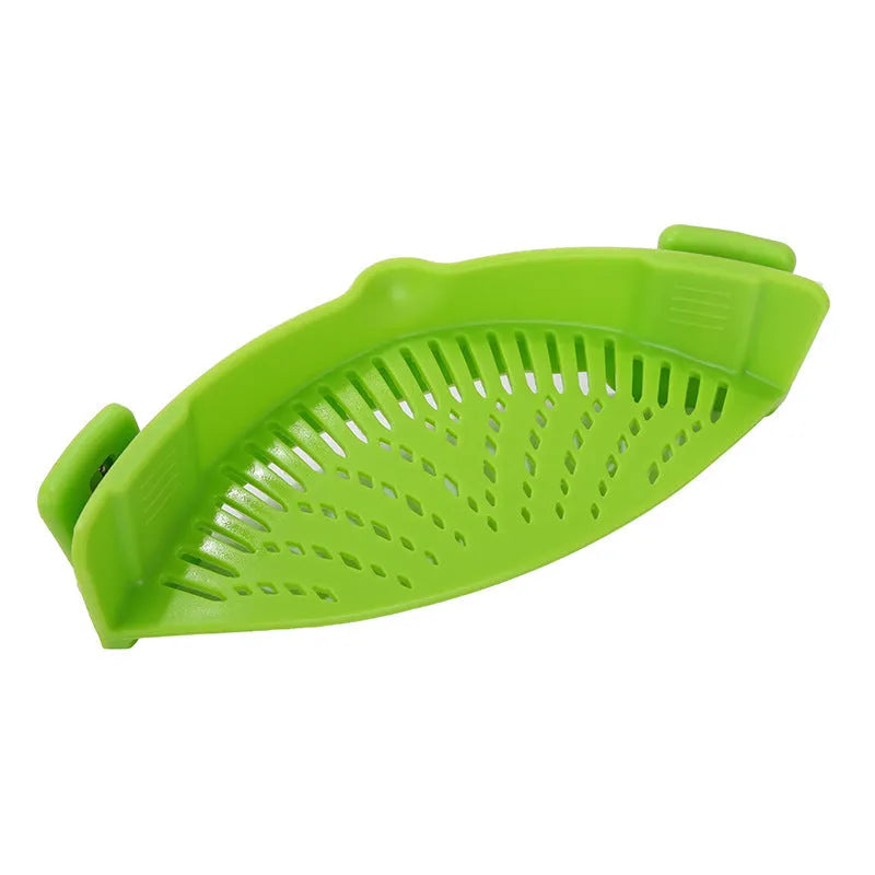 Silicone clip-on funnel strainer attached to a pot rim for draining liquids.