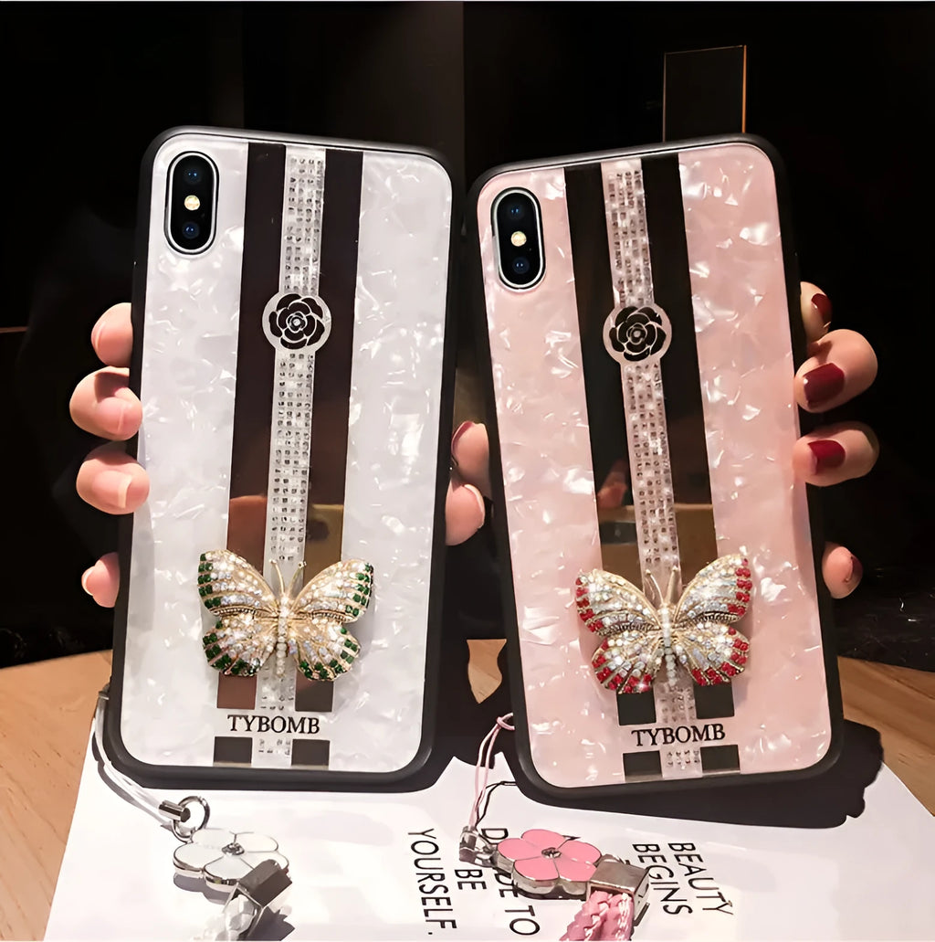Luxury acrylic iPhone case with crystal butterfly design and mirror back, shown in purple.