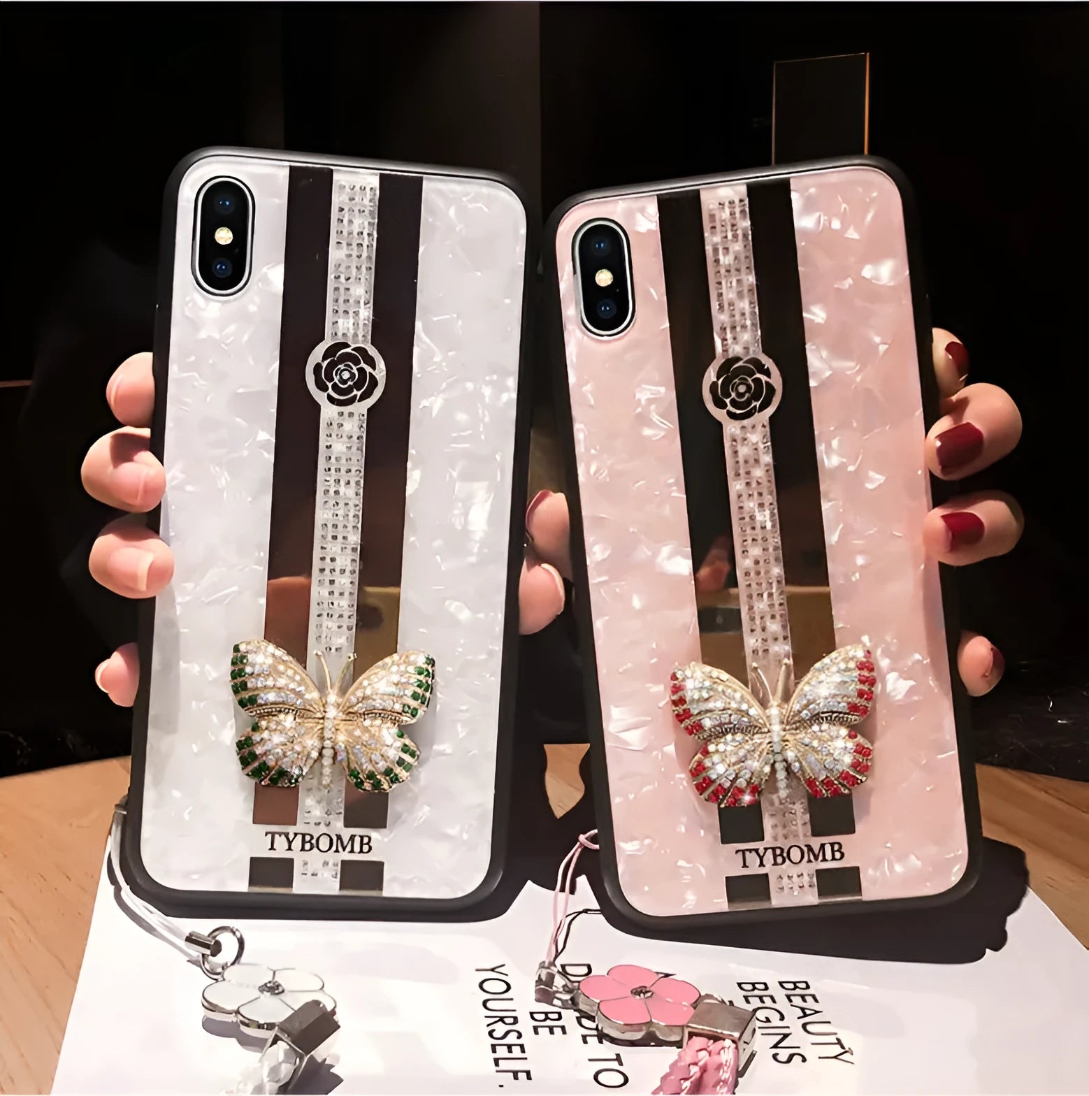 Luxury acrylic iPhone case with crystal butterfly design and mirror back, shown in purple.