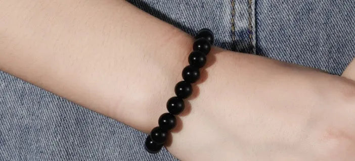 Geometric black onyx stretch bracelet with 8mm agate beads on an elastic cord.
