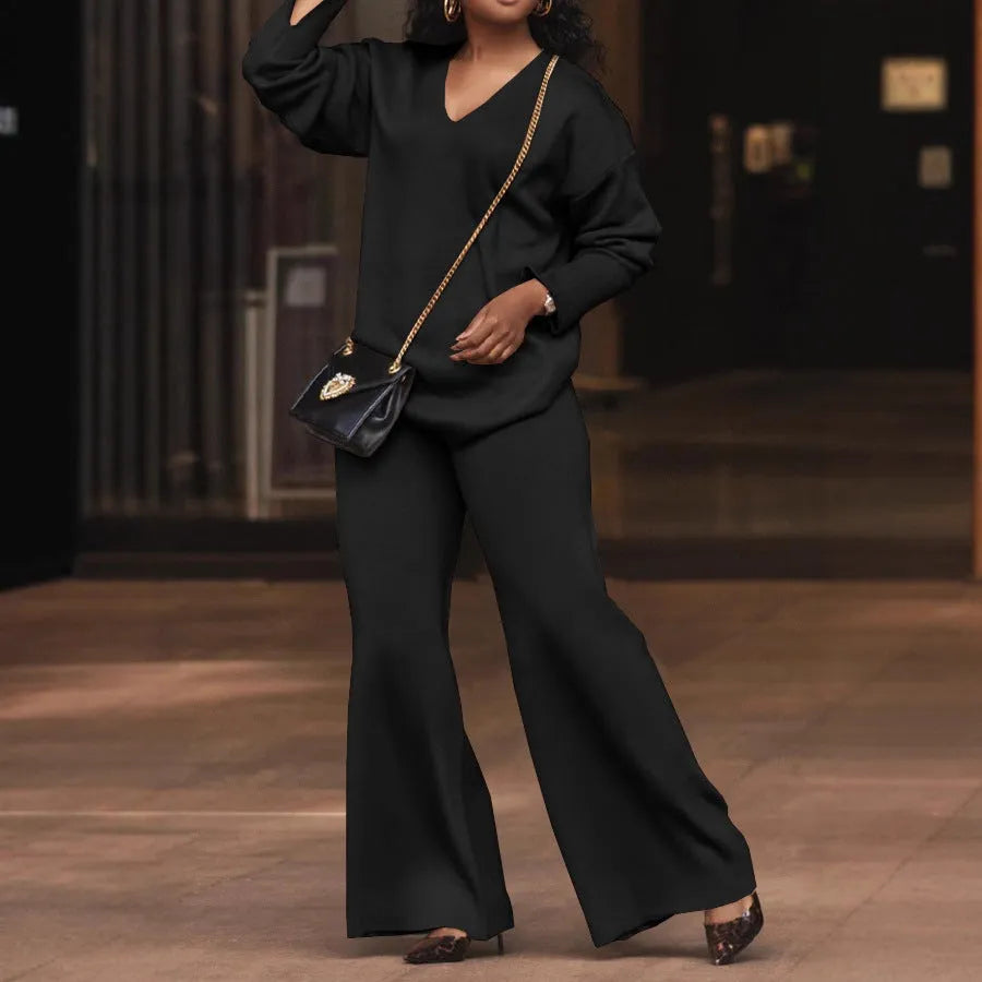 Women's brown thickened velvet two-piece suit with split sleeve top and trousers on a hanger.