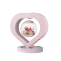 Pink preserved rose ornament with LED lights on a base, with optional audio Bluetooth for music.