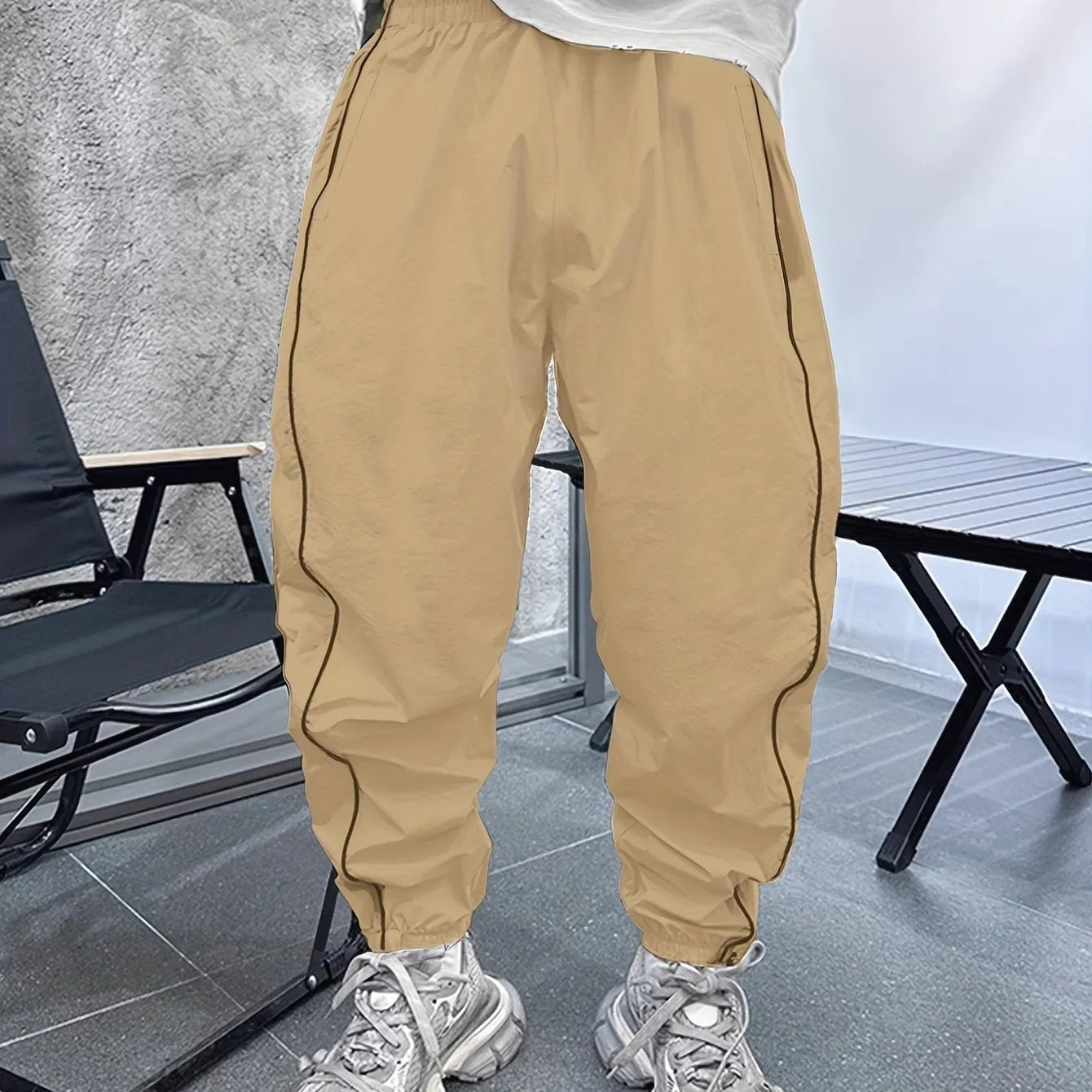 Men's blue bamboo fibre casual sports trousers with cropped length and loose fit on a hanger.