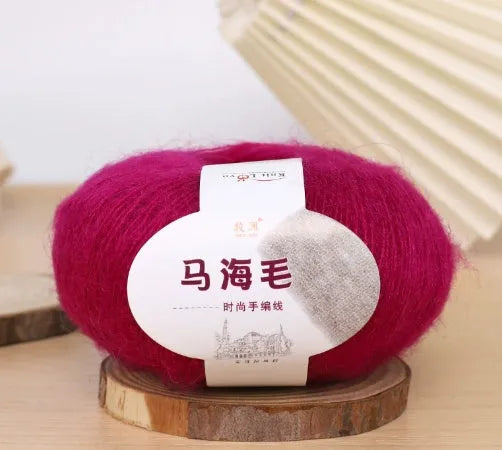 Ball of mohair yarn for DIY scarf knitting in one of 34 colours, including white, pink, blue, and green.