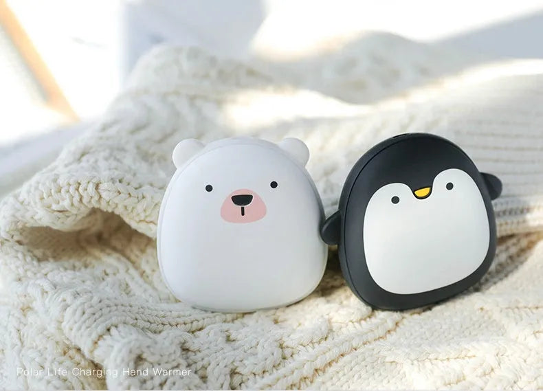 Cartoon penguin polar bear USB rechargeable hand warmer and power bank unit.