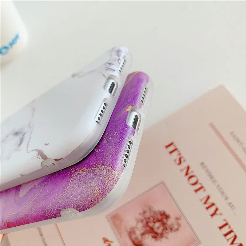 Cartoon marble pattern TPU back cover case for iPhone on a blue powder background.