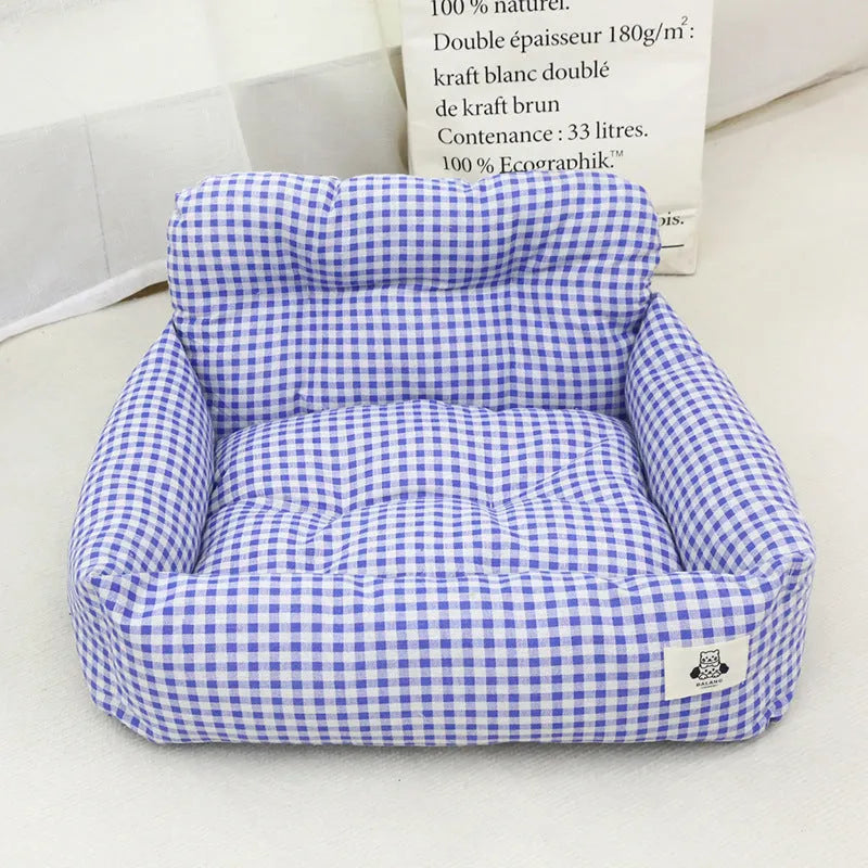 Grey and blue plaid cloth dog bed designed for car travel, shown in small and large sizes.