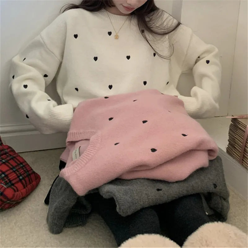 Women's loose fit acrylic pullover sweater in milky white, showing crew neck and long sleeve design.