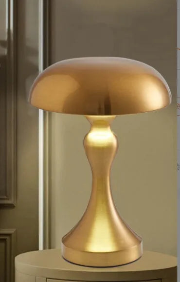 Metallic bronze touch-control LED desk lamp showing tri-colour light settings on a wooden desk.