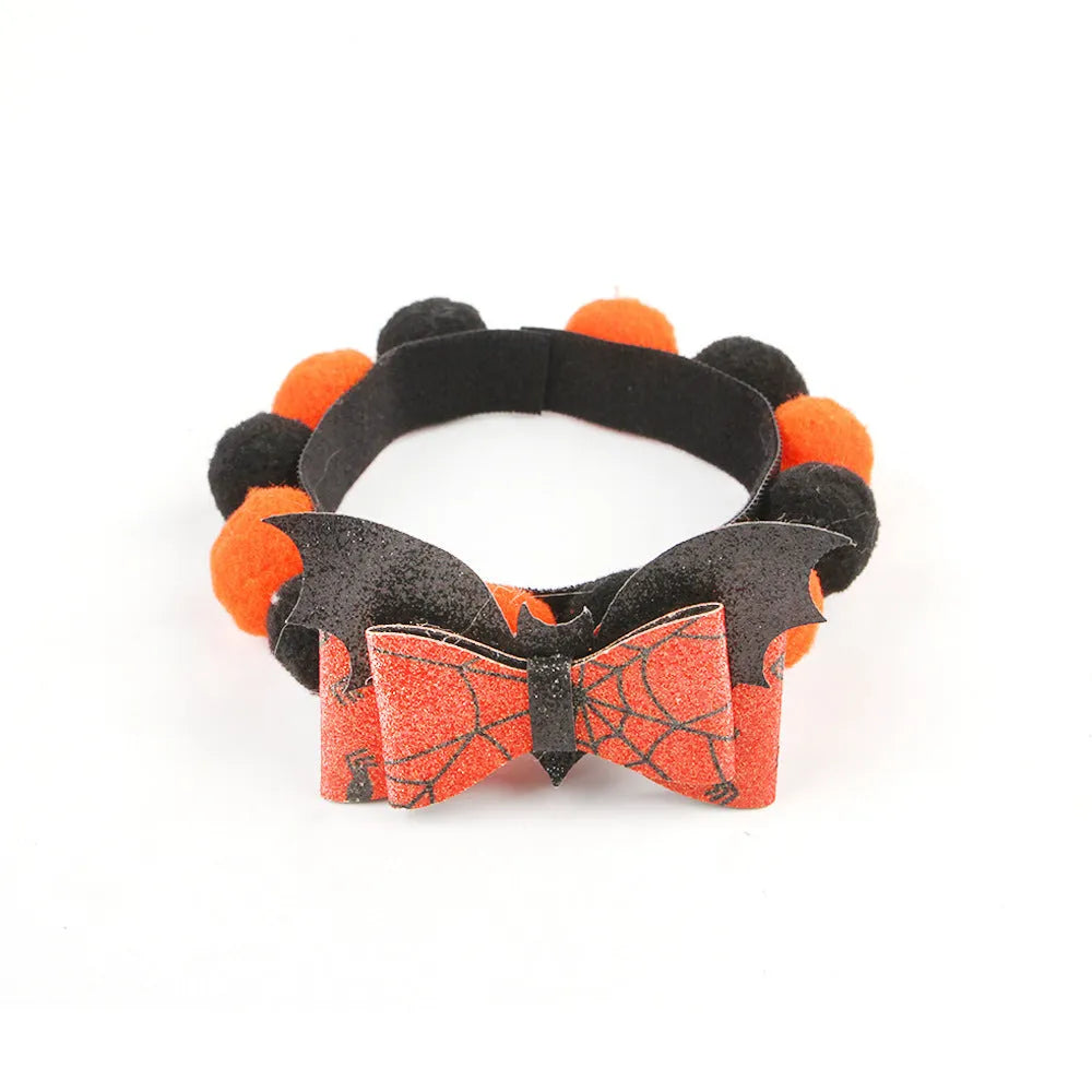 Halloween pet collar with fur ball decoration in pumpkin design on dog neck