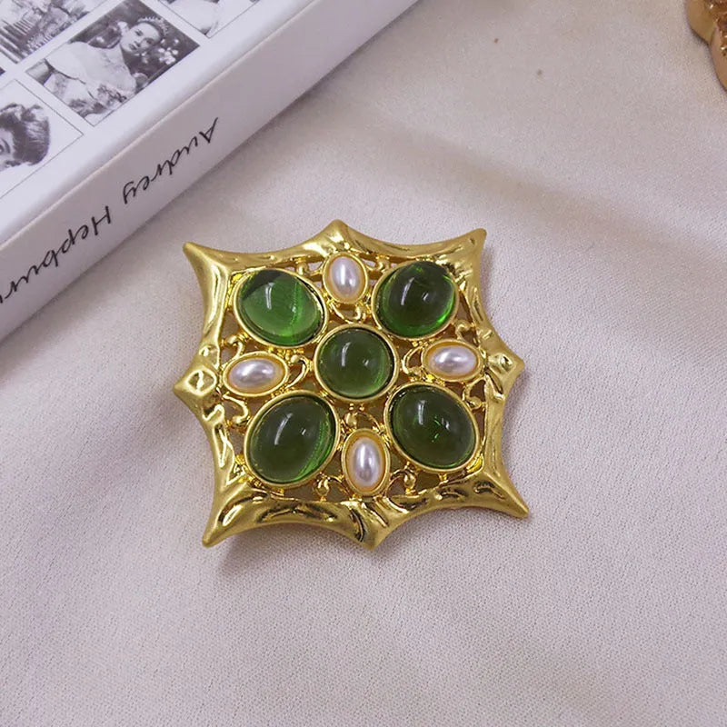 Close-up of a vintage medieval baroque cross brooch in zinc alloy with crystal accents, showing intricate detail.