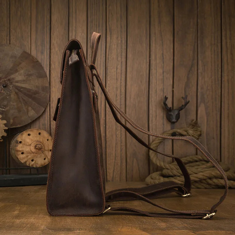 Dark brown genuine leather travel bag with shoulder straps and organised internal compartments