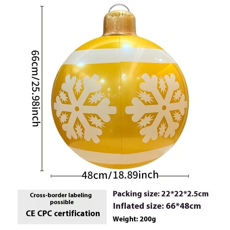 Large red and white inflatable Christmas ball with flashing lights in a garden setting