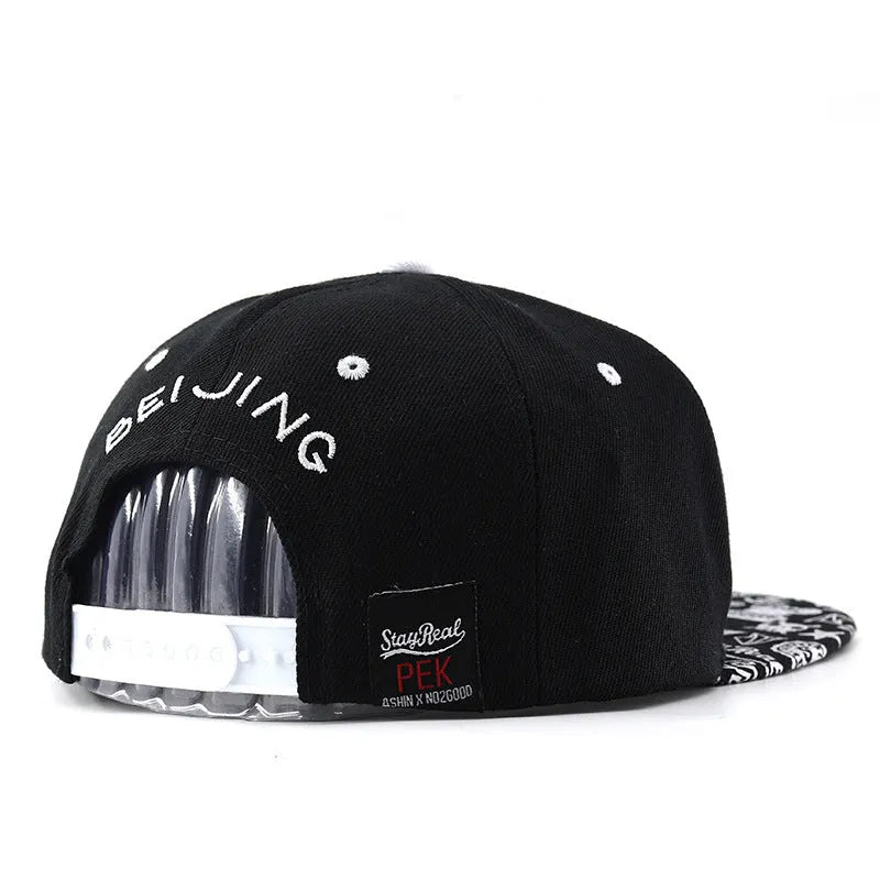 Adjustable black cotton baseball cap with white letter embroidery on the front, showing dome crown shape.