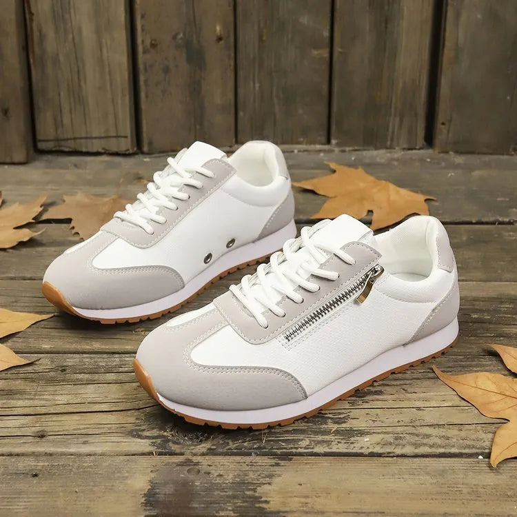 Women's flat-heeled shoes in grey, white and Champagne colours with artificial PU upper and rubber sole.