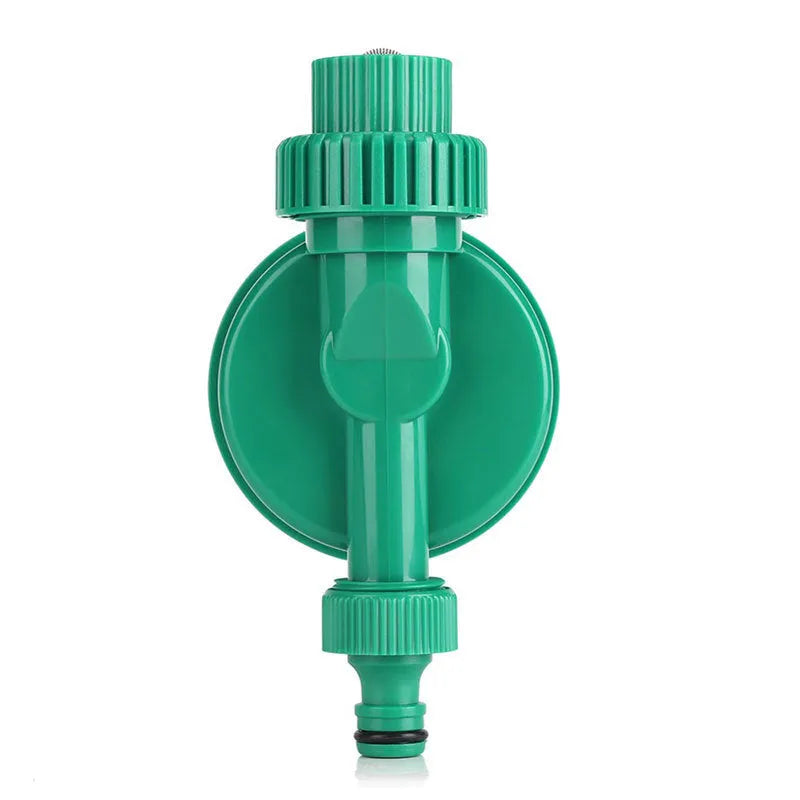 Green plastic automatic watering timer with digital display for garden hose connection.