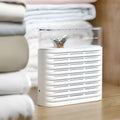 White reusable electric dehumidifier box with transparent top showing orange silica gel beads, for cabinets and wardrobes.