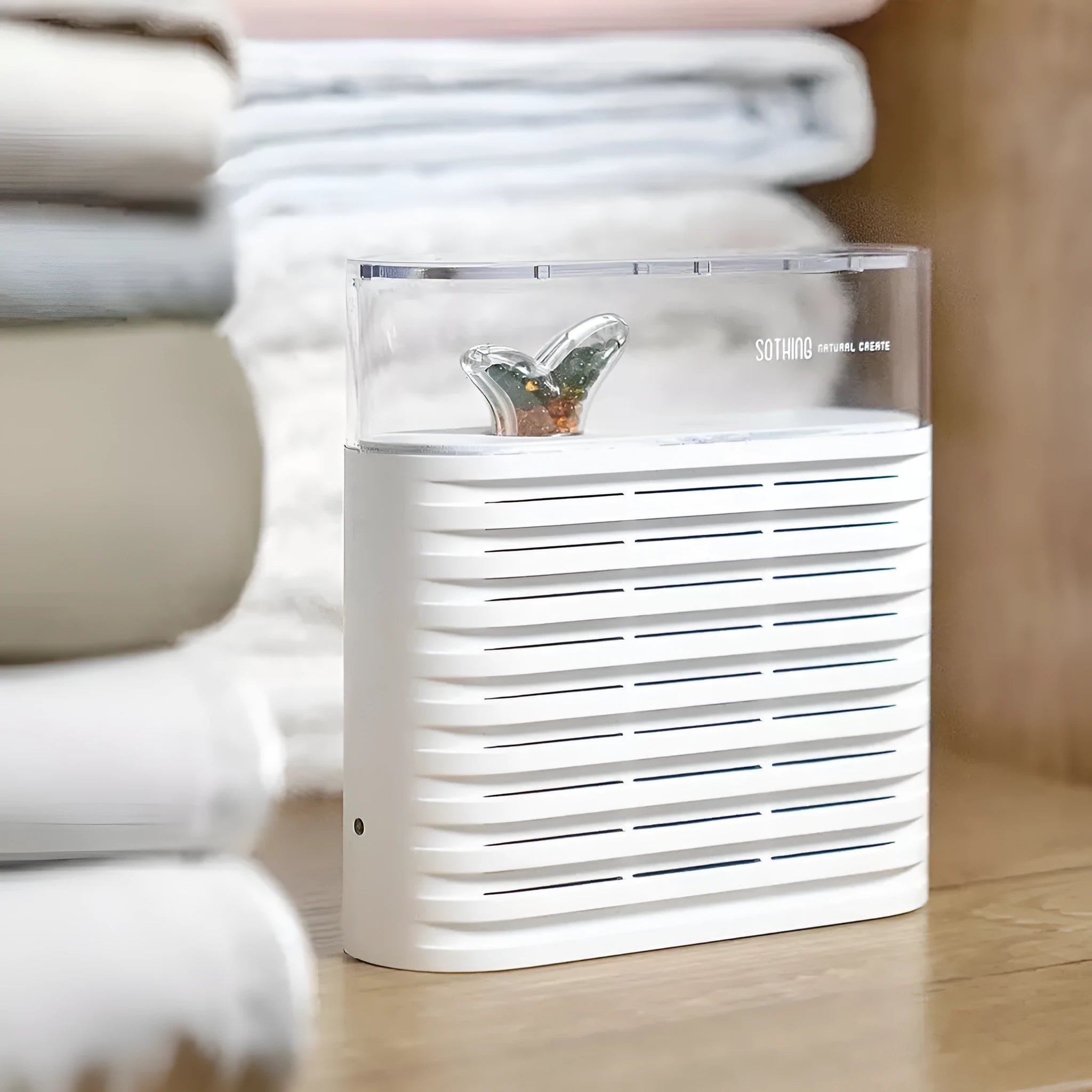 White reusable electric dehumidifier box with transparent top showing orange silica gel beads, for cabinets and wardrobes.