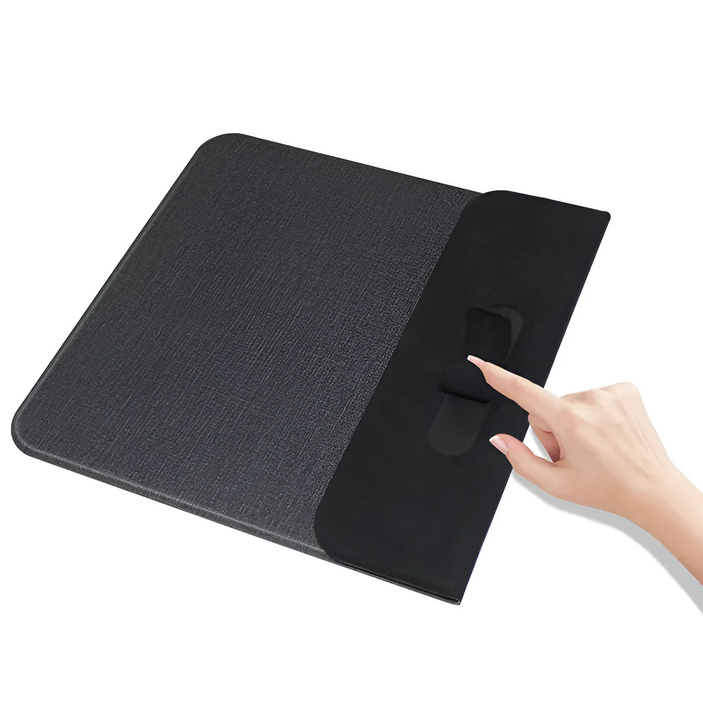 Black foldable fabric wireless charging phone holder standing upright on a desk.