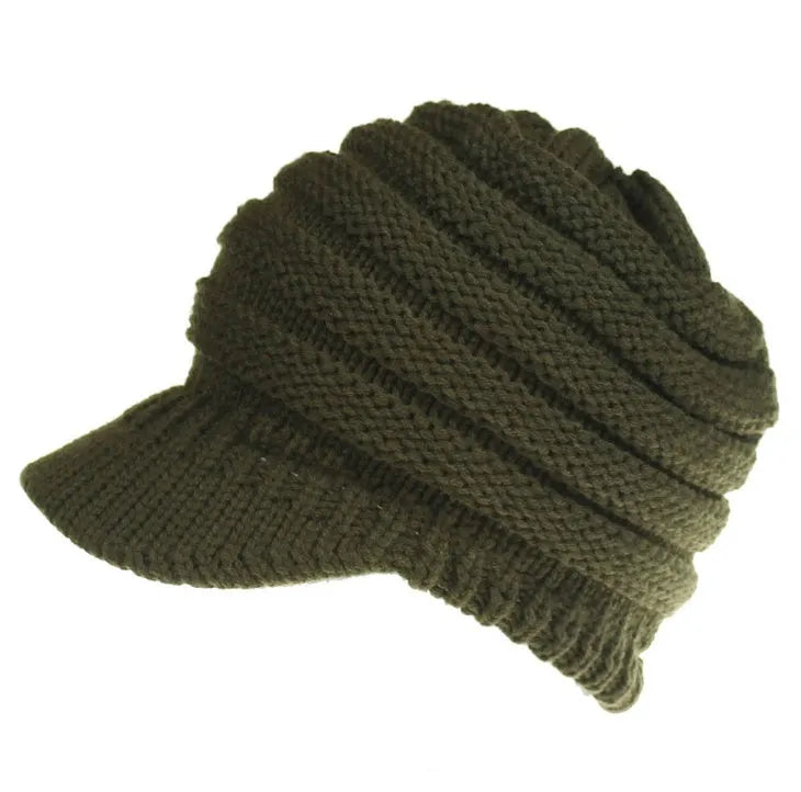 Acrylic knitted ponytail beanie hat for women in a neutral colour, shown on a model with a high ponytail.