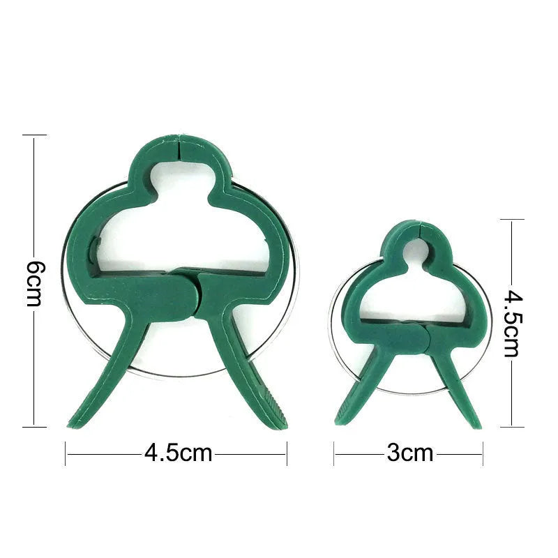 Green plastic and zinc plant fixing clips in large and small sizes for securing climbing plants.