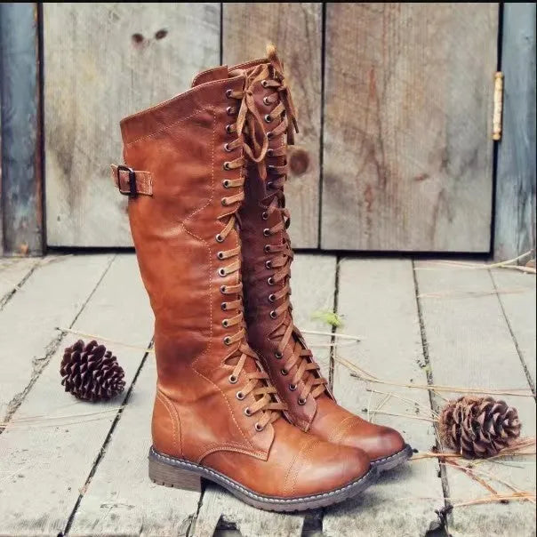 Women's black chunky heel high leg boots with a round toe and low profile.