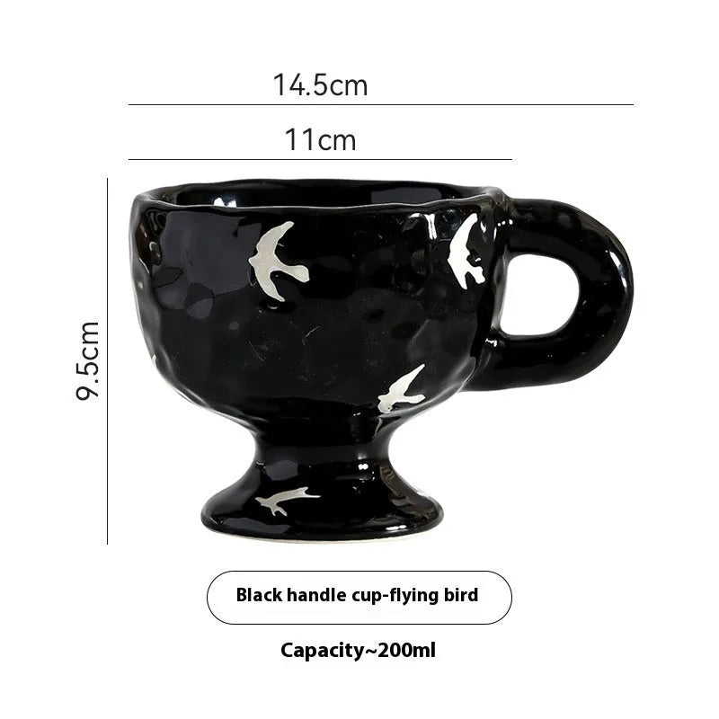 Handmade irregular solid colour ceramic mug on a table, showing its unique shape.