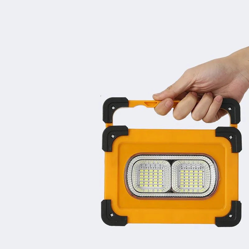 Yellow outdoor portable solar LED light with power bank and magnetic base, 36LED lamp beads model 5730, sitting on a metal surface