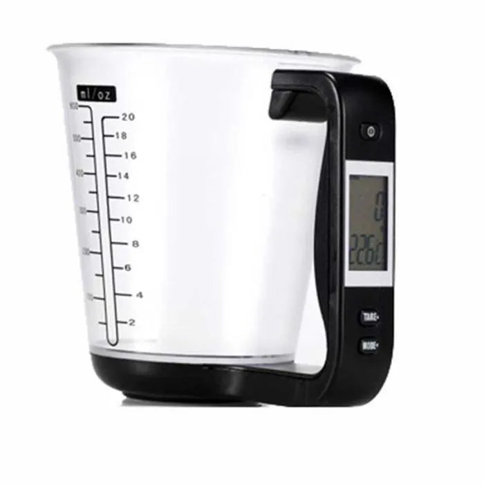 Green digital kitchen scale measuring cup with LCD display in handle on kitchen counter