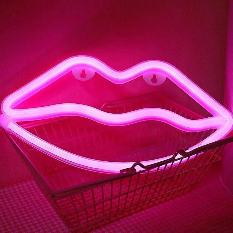 Pink lips-shaped neon light sign on wall with USB cable and battery backup