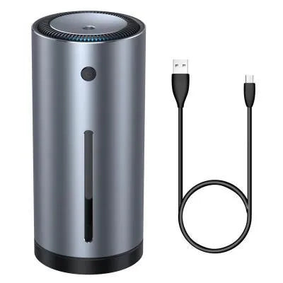 Black aluminium alloy car humidifier with USB cable and 12V car adapter plug on a desk.