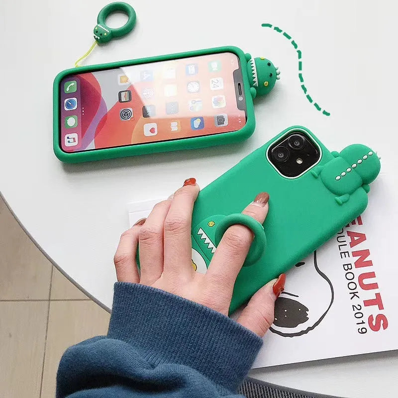 Green and yellow silicone iPhone cases with animal cartoon designs on a white background.