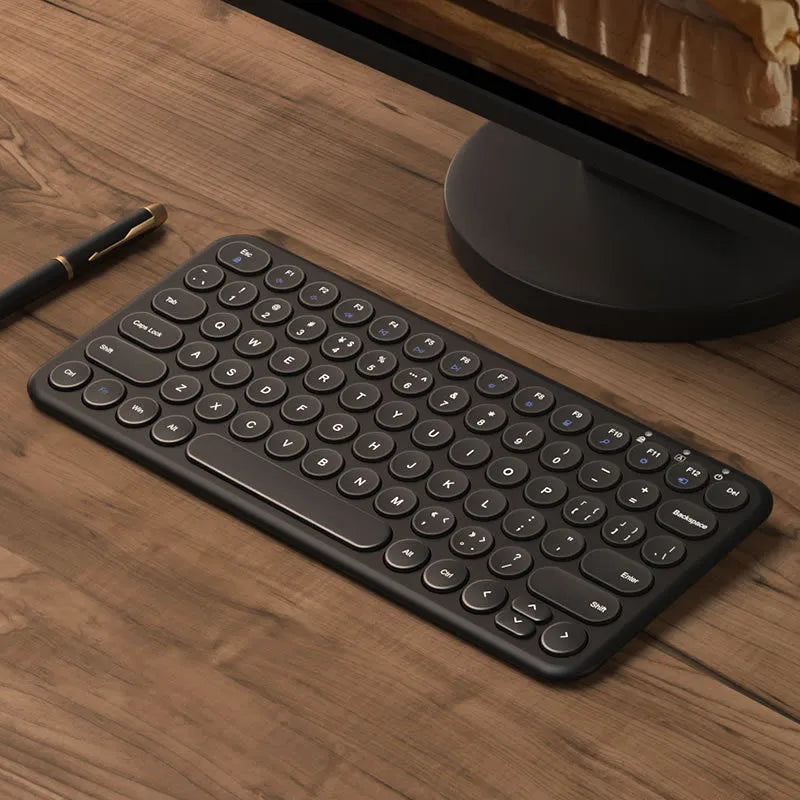 Mute white ultra-thin wireless keyboard and mouse with tiny USB receiver on a wooden desk