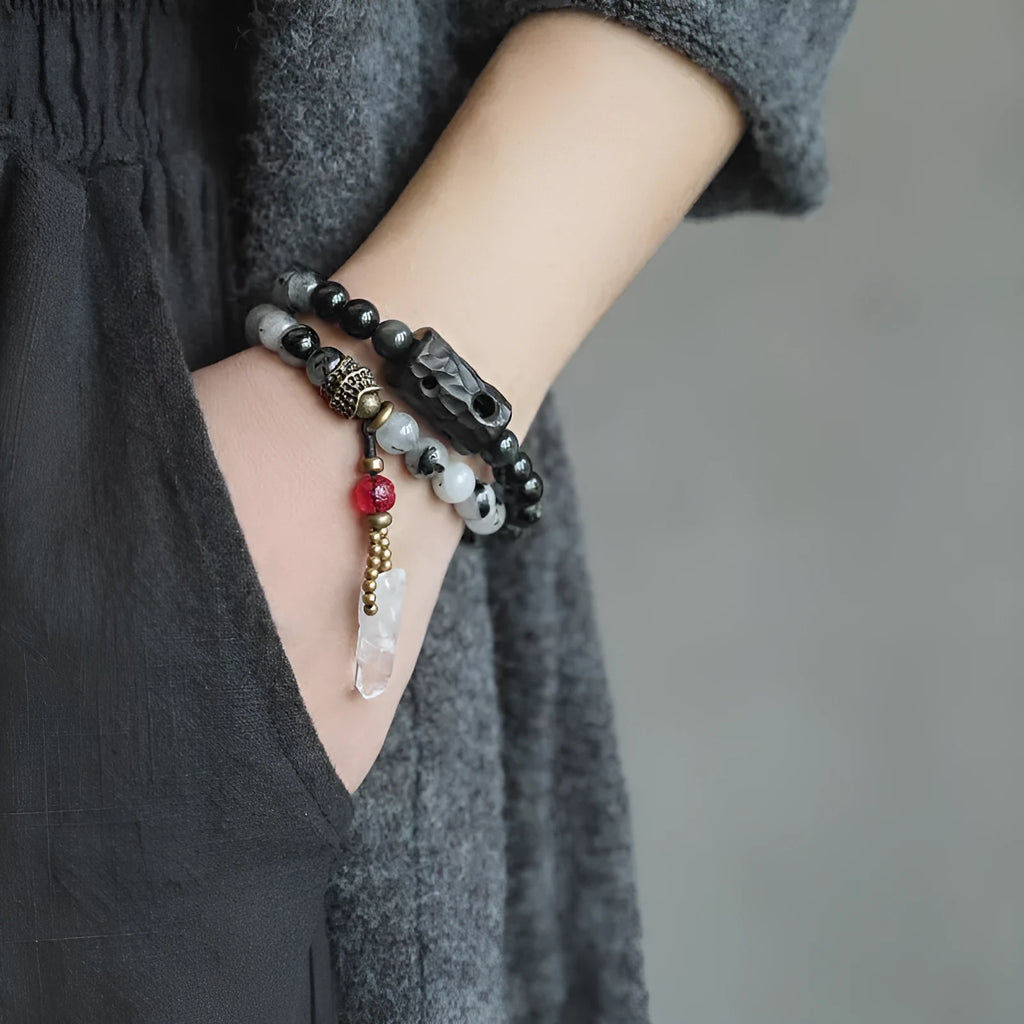 Men's ethnic black hair bracelet with white crystal tassel showing bending and lacing details