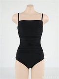 Blue sling style one-piece swimsuit with belly pleating on a model