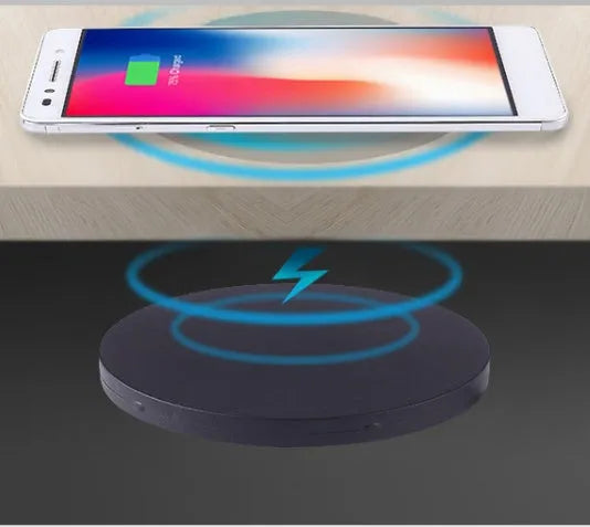 Black 60mm round wireless phone charging pad for furniture installation