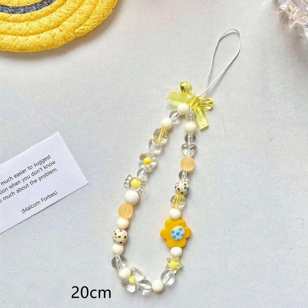 Blue, pink, and yellow floral beaded phone lanyard with plastic resin charms.