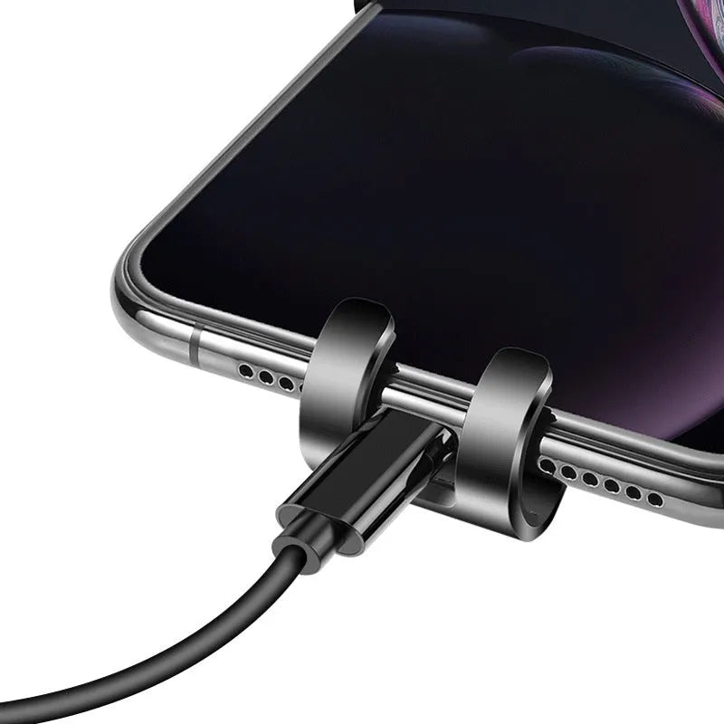 Black ABS gravity phone holder mounted on a car air vent with a mobile phone secured.
