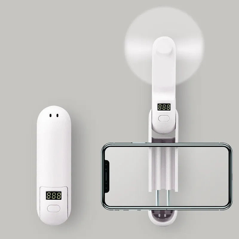 A green folding mini USB fan with plastic blades, shown in open and closed positions.