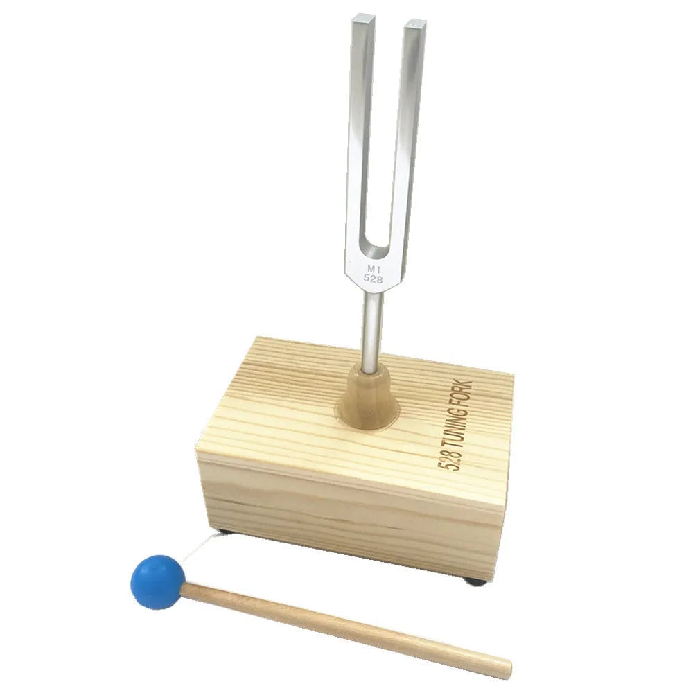 Aluminium alloy 432Hz tuning fork and portable speaker kit on a kraft paper box.
