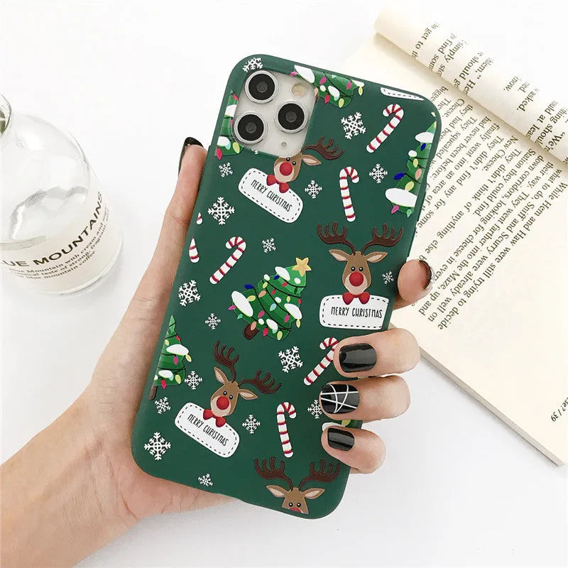 Green TPU iPhone case with a cartoon Christmas elk and tree design and stripe pattern.