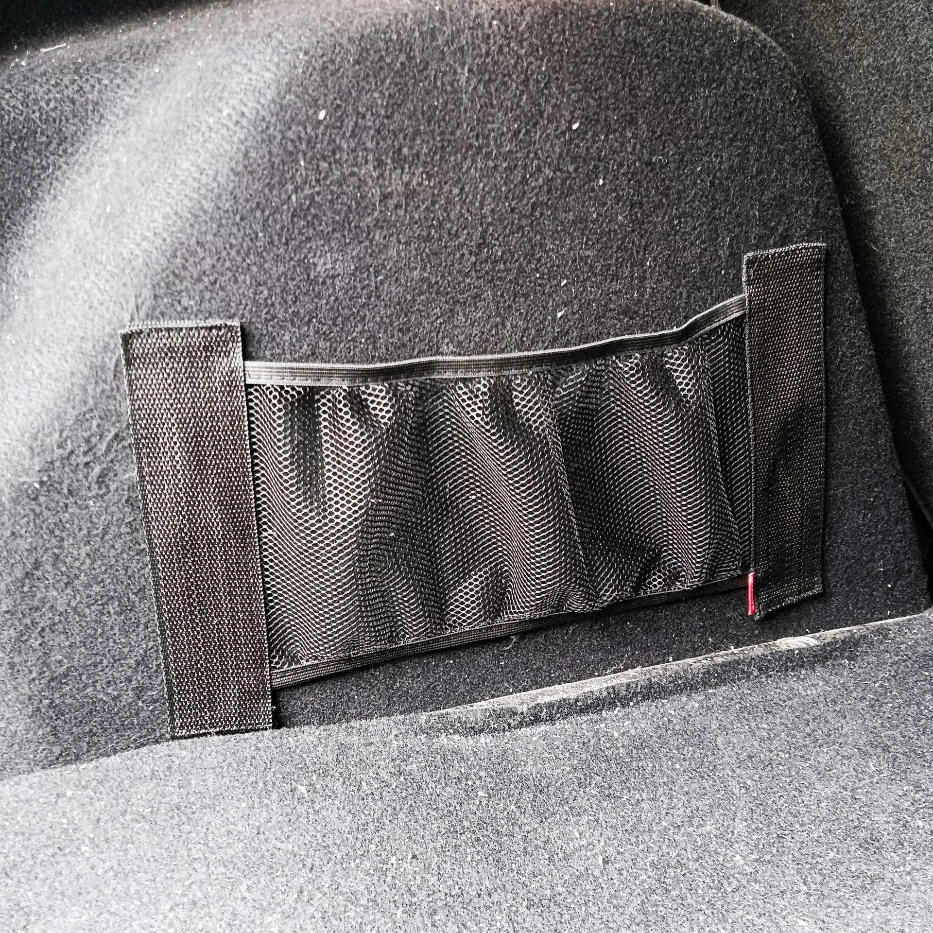 Black elastic polyester storage net for organising items in a car boot, shown in 20x35cm and 20x45cm sizes.