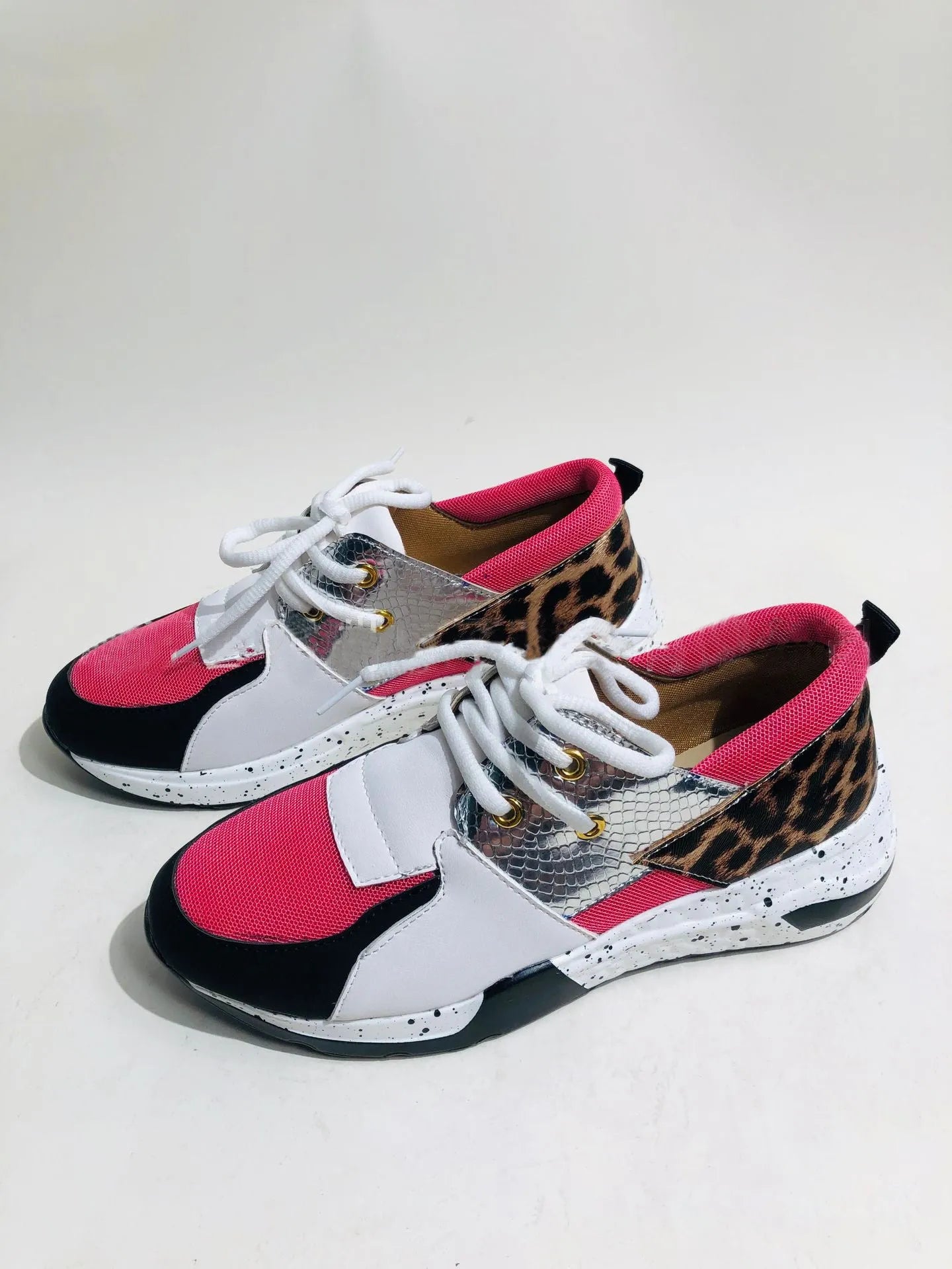 Women's casual suede wedge sneakers in leopard print with a low-cut design and plastic sole.