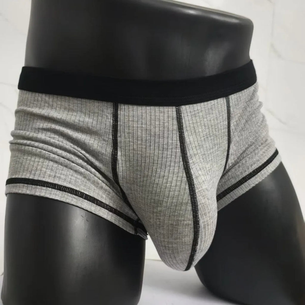 Men's solid colour breathable boxer shorts on a white background showing hip lifting design.
